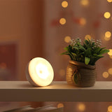 Motion sensor night light glowing warm on a shelf