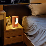 Wood block lamp on a bedside table