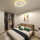 Overlapping ring flush mount lit in a bedroom