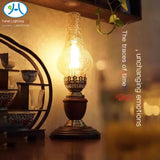 Brass and wood-base chimney lamp lit warm