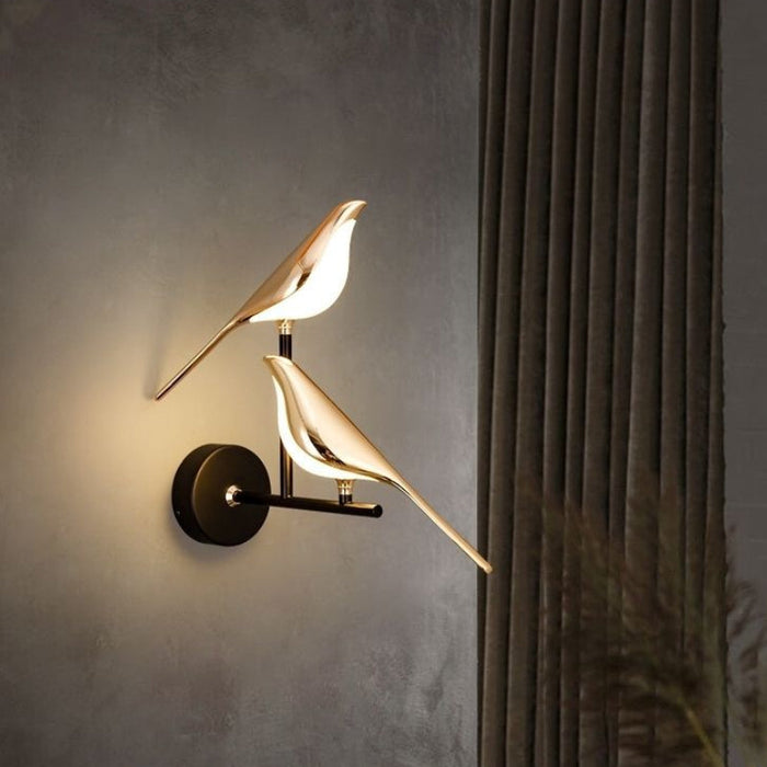 Gold bird wall sconce on a white background