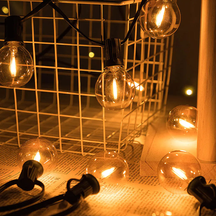 G40 globe string lights lit over a patio at night