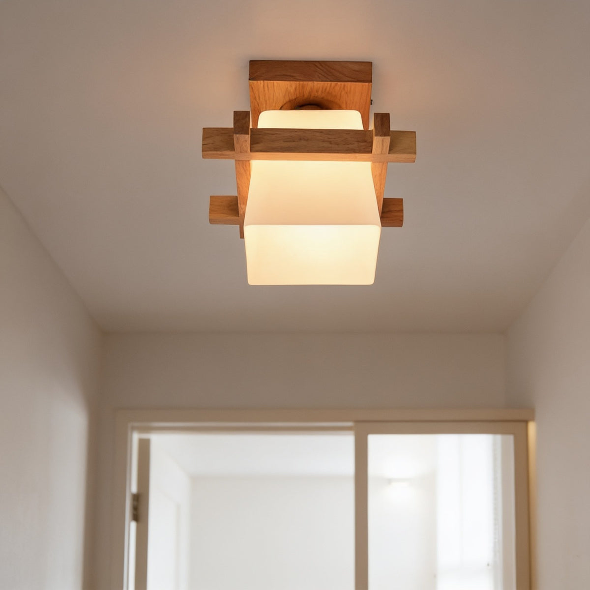 Nordic wood frame ceiling light with frosted glass shade in a bright hallway