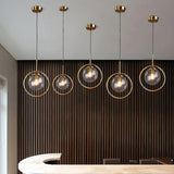 Row of glass globe pendants over a kitchen counter