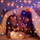 Starry projection over a bed at night
