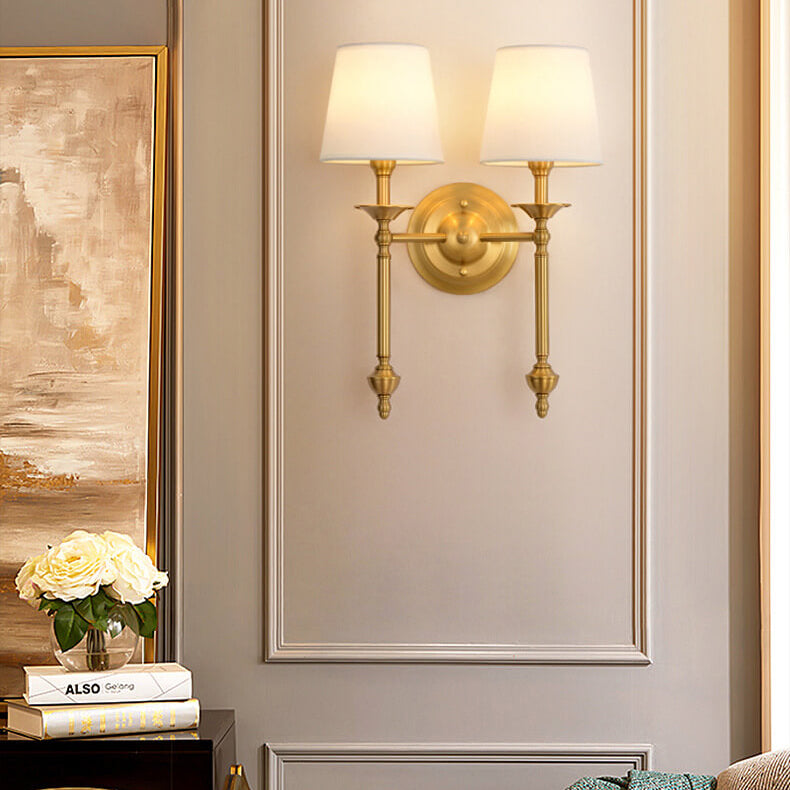 Two-arm brass wall light with white fabric shades
