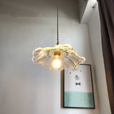 Glass flower pendant lit with an Edison bulb
