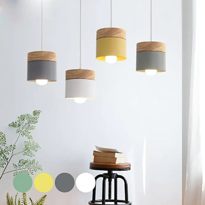 Wood and metal cylinder pendant lights hanging in a row