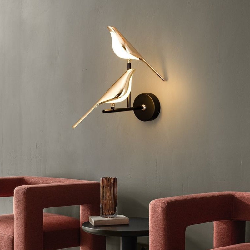 Bird sconce lit, casting light down the wall