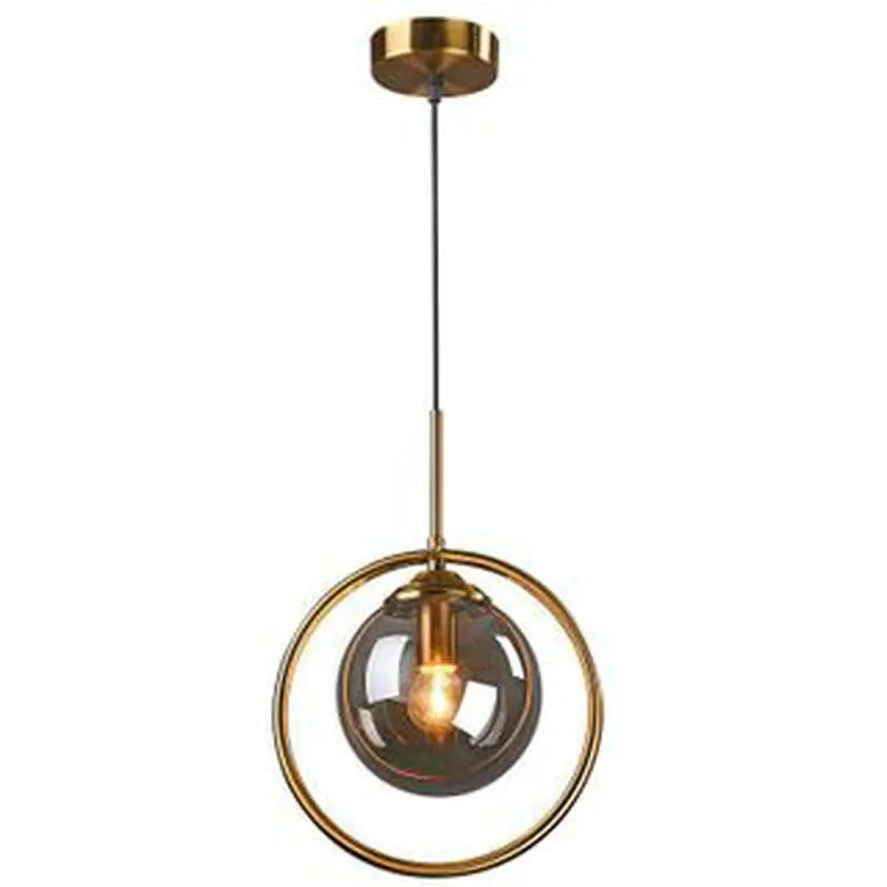 Glass globe pendant light in a brass ring, white background