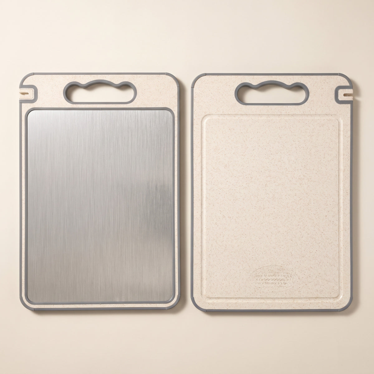 Both faces of the cutting board: brushed stainless steel and cream composite