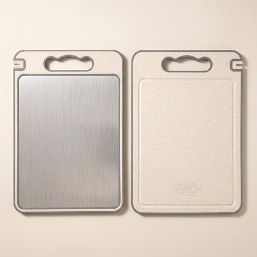 Both faces of the cutting board: brushed stainless steel and cream composite