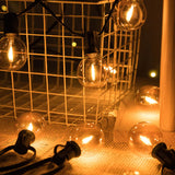 G40 globe string lights lit over a patio at night
