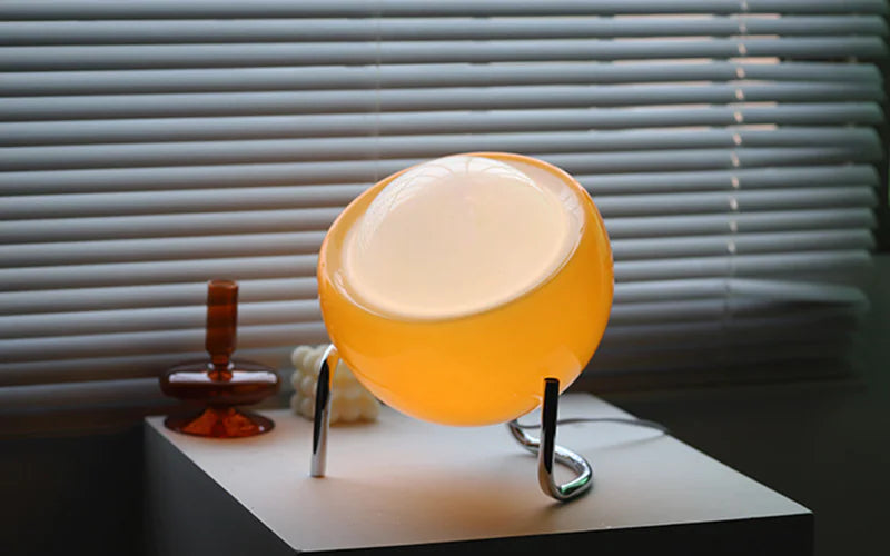 Glass globe bedside lamp on a table