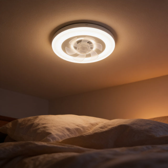 White flush mount ceiling fan light with recessed blades above a bedroom