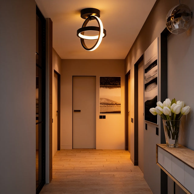Black interlocking rings LED ceiling light in a hallway above a console