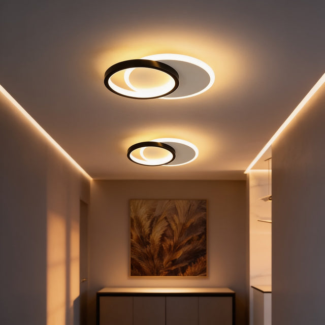 Overlapping black and white ring flush mount ceiling light in a hallway