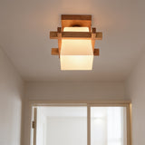 Nordic wood frame ceiling light with frosted glass shade in a bright hallway