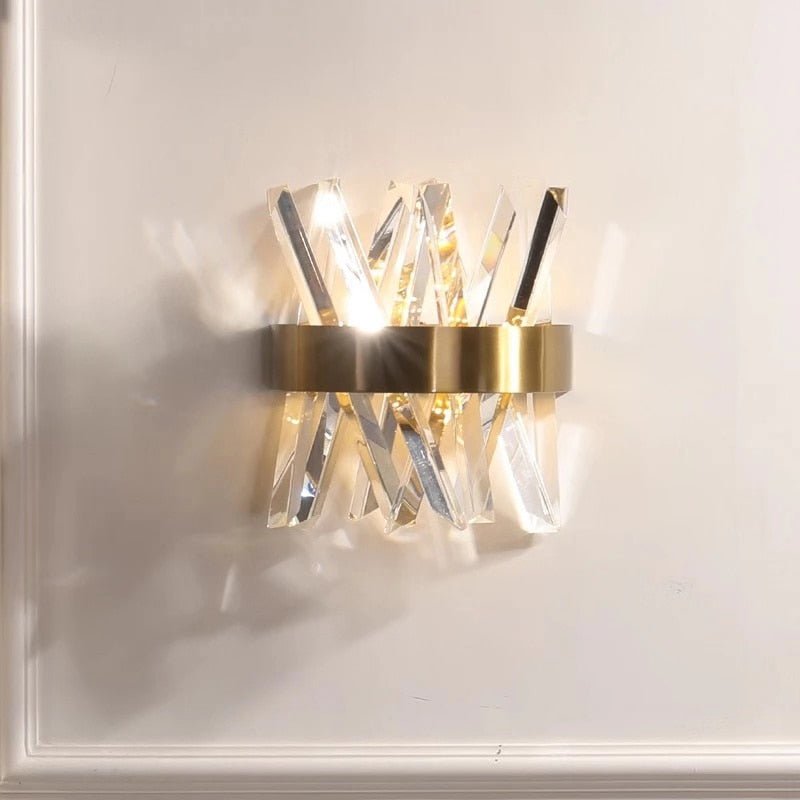 Crystal wall sconce in a brass band, white background
