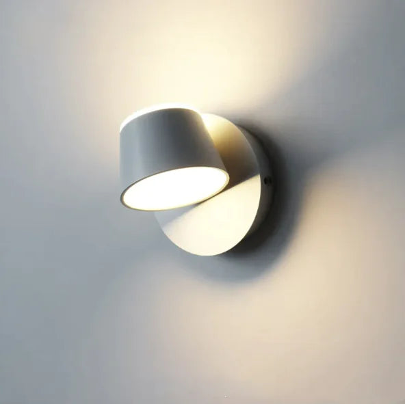 Cordless magnetic wall sconce in white, head rotated