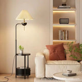 Floor lamp with side table beside a sofa