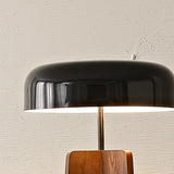 Black dome shade detail on the walnut lamp