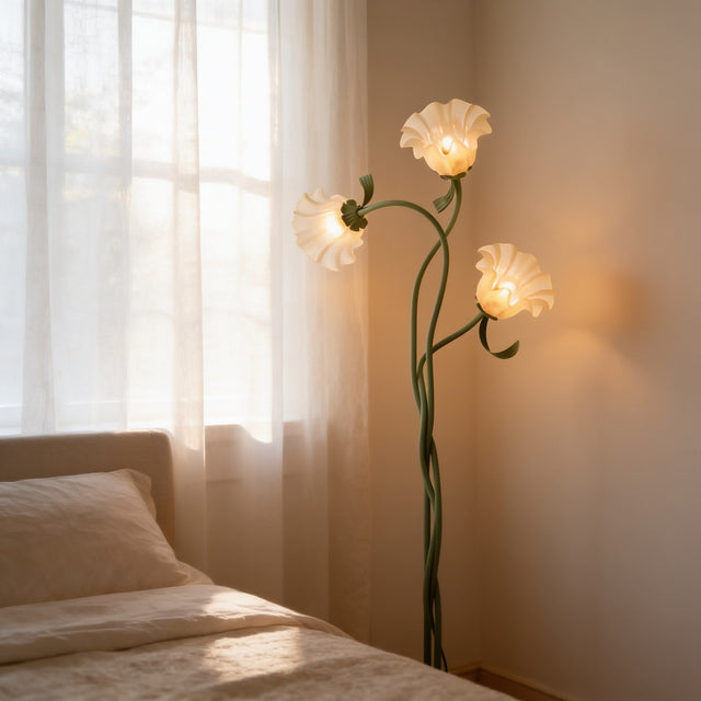 Floral floor lamp with cream flower shades on green stems in a bedroom corner