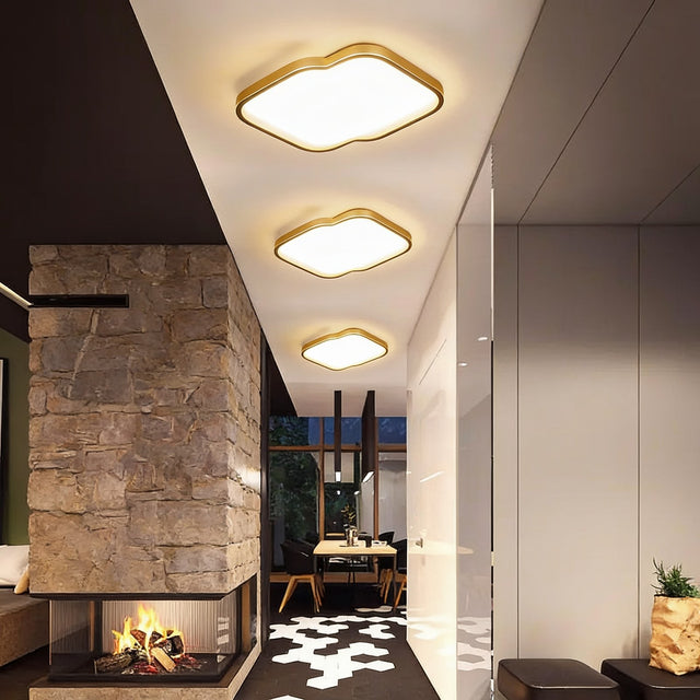 Gold trimmed square flush mount ceiling lights along a modern corridor