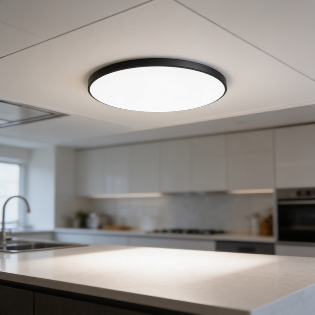 Ultra-thin round LED ceiling panel with black rim above a kitchen worktop