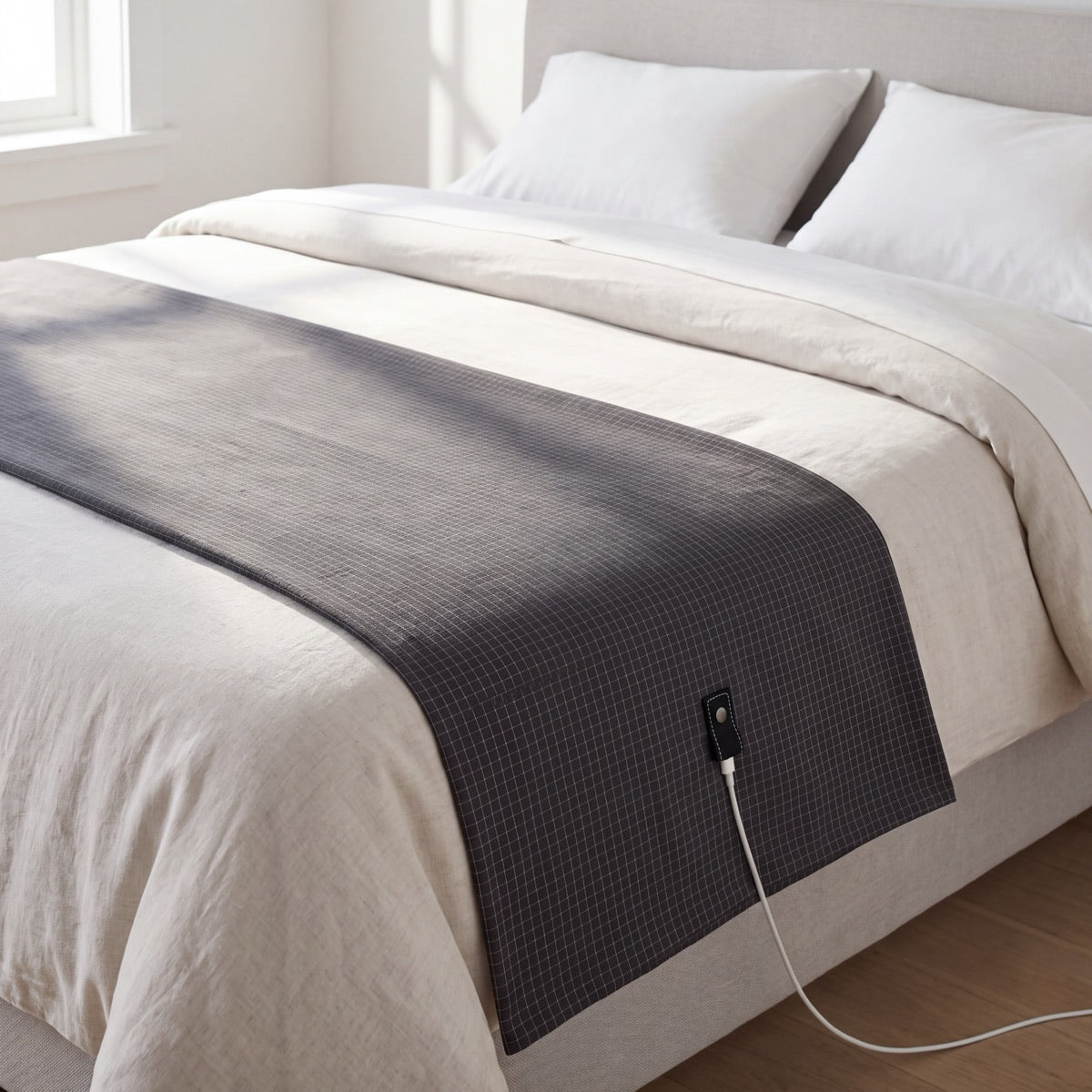 The Nostra Grounding Sheet laid across a made bed in morning light