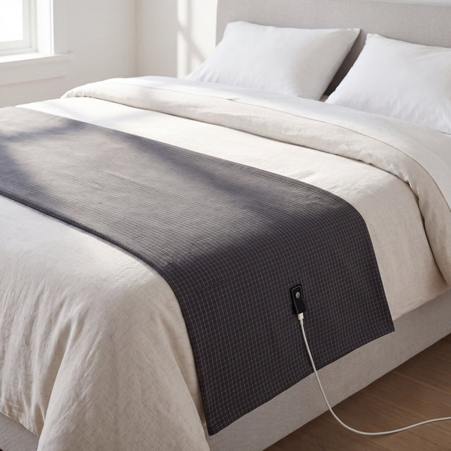 The Nostra Grounding Sheet laid across a made bed in morning light