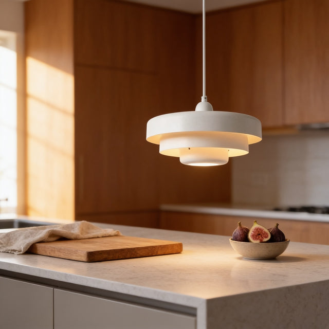 White tiered disc macaron pendant light above a quartz kitchen island