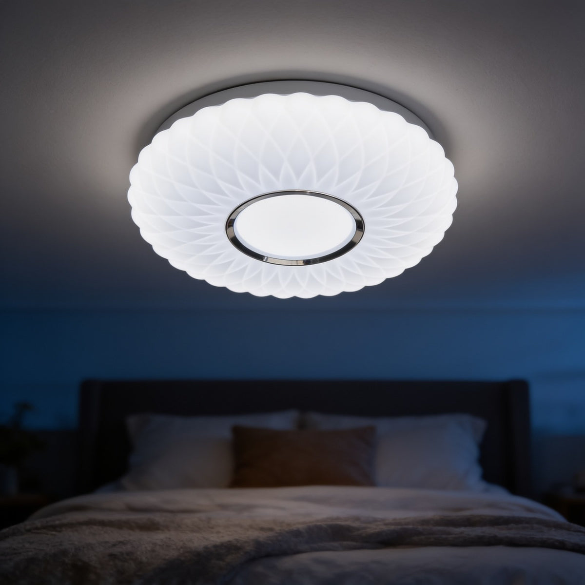 Fluted white dome LED ceiling light glowing above a bed