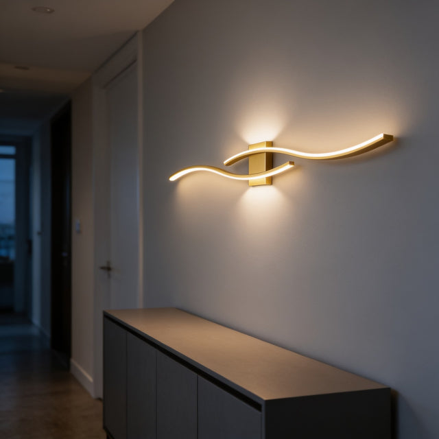 Gold wave-shaped LED wall bar glowing above a sideboard in a hallway