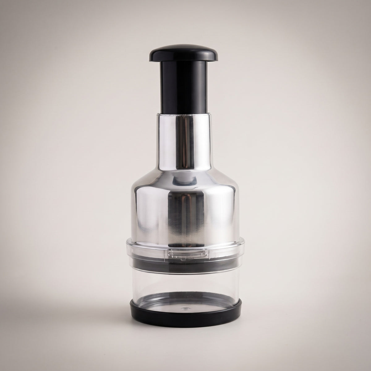 Stainless Steel One-Press Food Chopper with clear collection cup, studio packshot