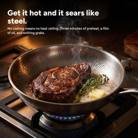 Searing a steak at high heat in the titanium pan
