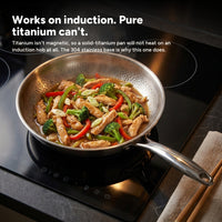 A finished stir-fry in the pan on a black glass induction hob