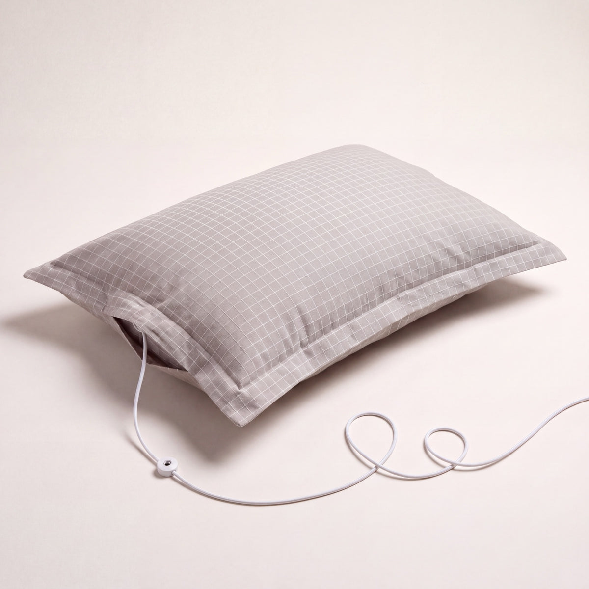 The Nostra Grounding Pillowcase, studio shot, with its grounding cord