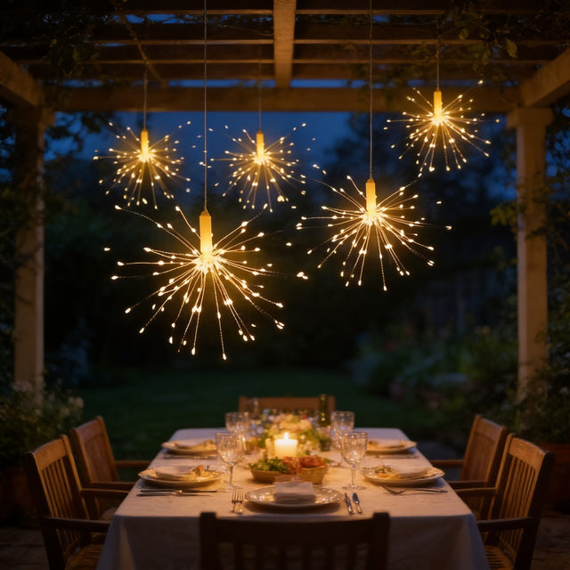 Starburst firework fairy lights hanging over an outdoor dining table at night