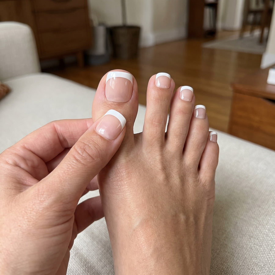 Pressing a full-cover toenail into place while sitting on the sofa