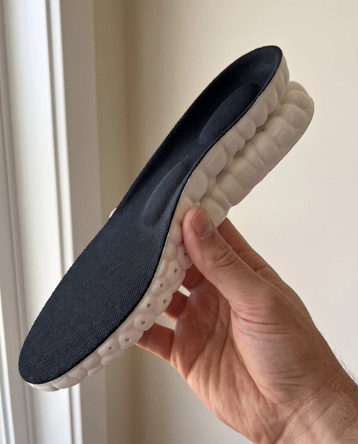 Cloud Insole held in hand, showing the full thickness of the foam