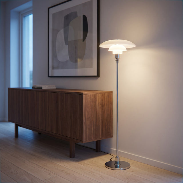 Bauhaus PH tiered shade floor lamp on a chrome stem beside a walnut sideboard